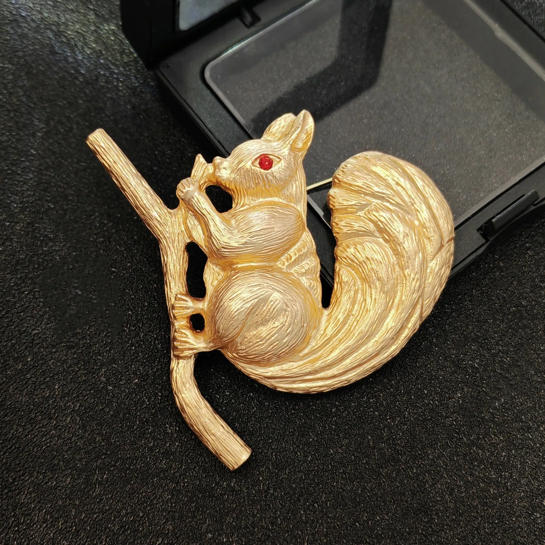 Adorable Gold - toned Squirrel Brooch on Branch with Red - eyed Detail