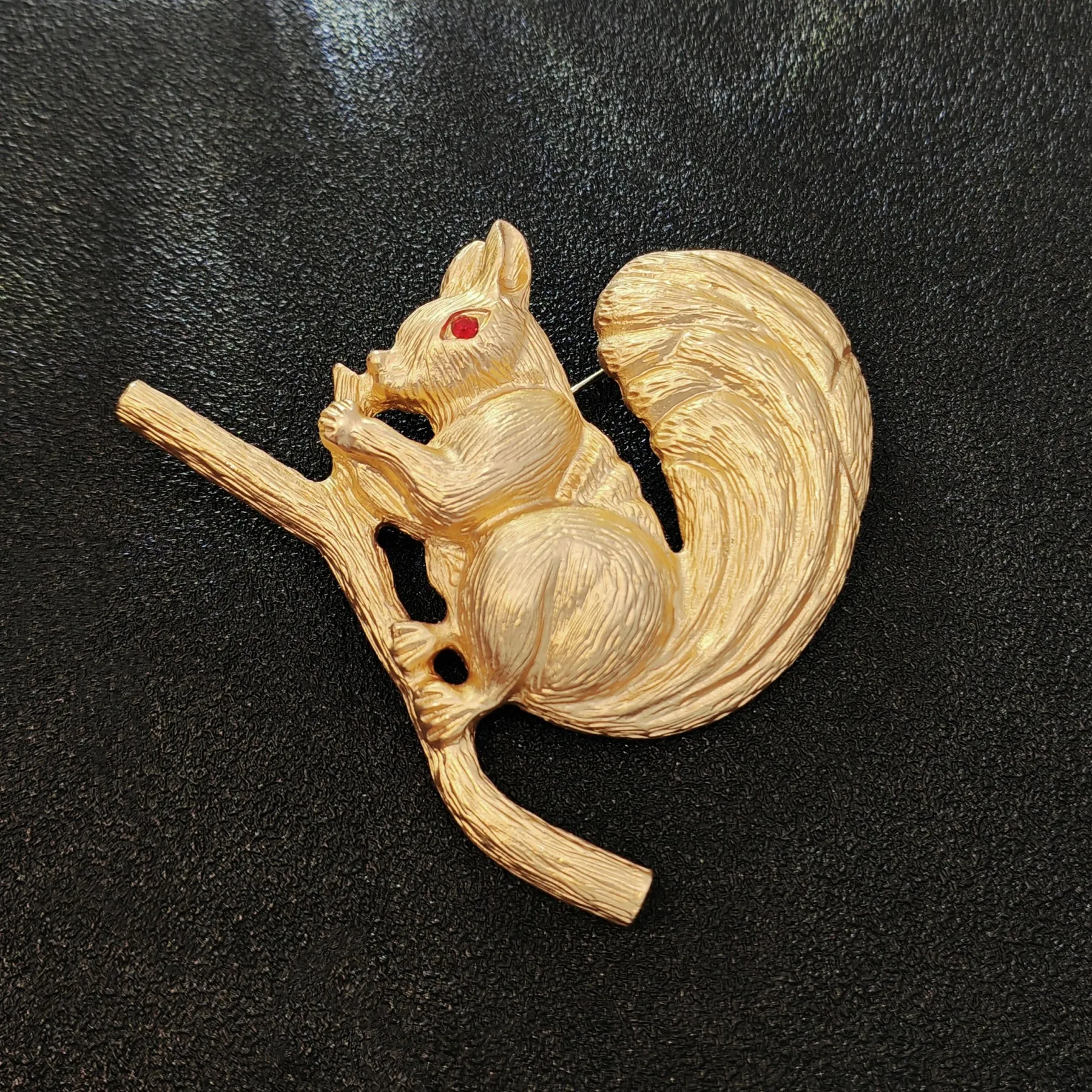 Adorable Gold - toned Squirrel Brooch on Branch with Red - eyed Detail