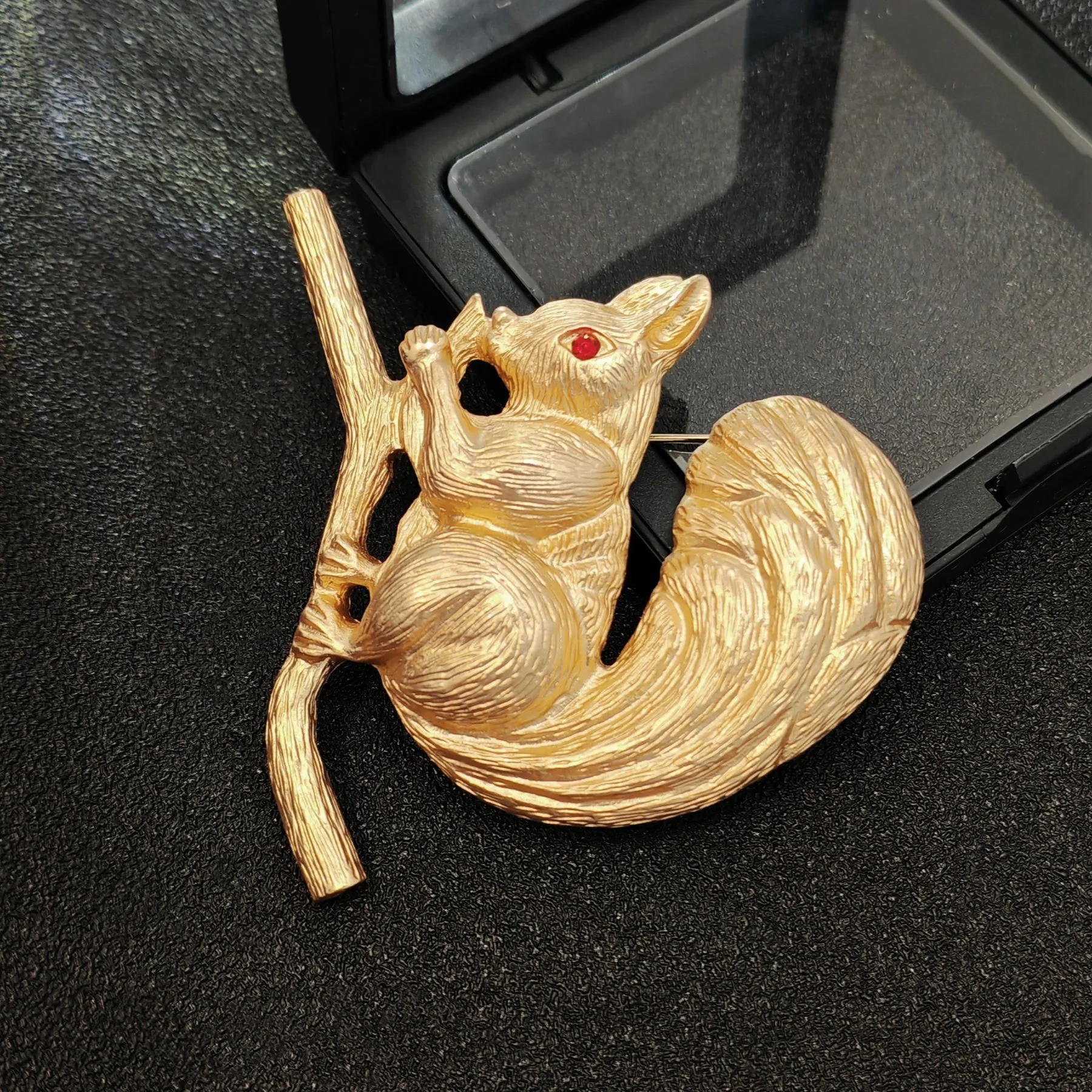 Adorable Gold - toned Squirrel Brooch on Branch with Red - eyed Detail